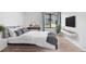 A beautifully staged main bedroom with natural lighting, modern decor, and laminate wood flooring at 3656 S Depew St # 102, Denver, CO 80235