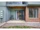 A cozy patio with chairs and a sliding glass door leading into the home's interior at 3656 S Depew St # 102, Denver, CO 80235
