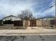 Backyard with dilapidated fence, overgrown weeds, and distant houses at 1021 Downing Way, Denver, CO 80229