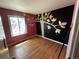 Bedroom with hardwood floors and whimsical tree mural on a black accent wall at 1021 Downing Way, Denver, CO 80229