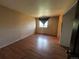 Bedroom with wood flooring, small window, and neutral paint at 1021 Downing Way, Denver, CO 80229