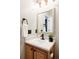 Updated bathroom with a vanity, mirror, and modern fixtures at 5604 S Yakima Way, Aurora, CO 80015