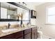 Double vanity bathroom with granite countertop and large mirror at 5604 S Yakima Way, Aurora, CO 80015