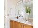 Bathroom with wood vanity, vessel sink, and modern mirror at 5604 S Yakima Way, Aurora, CO 80015