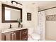 Bathroom with dark brown vanity, updated fixtures, and shower at 5604 S Yakima Way, Aurora, CO 80015