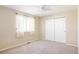 Bright bedroom with neutral walls, carpet, and double-door closet at 5604 S Yakima Way, Aurora, CO 80015