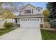 Two-story house with attached garage and landscaped front yard at 5604 S Yakima Way, Aurora, CO 80015