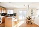 Kitchen with island, wood cabinets, and breakfast nook at 5604 S Yakima Way, Aurora, CO 80015