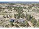 Panoramic aerial view of acreage with multiple residences nestled amongst a forest at 12454 Antelope Trl, Parker, CO 80138