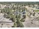 Aerial view of acreage featuring a sprawling property with lush trees and large buildings at 12454 Antelope Trl, Parker, CO 80138