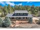 Beautiful aerial view of house, showing a well-manicured lawn, mature trees, and tasteful landscaping at 12454 Antelope Trl, Parker, CO 80138