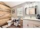 Charming bathroom featuring wood accent wall, white vanity and wood-look flooring at 12454 Antelope Trl, Parker, CO 80138