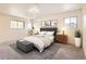 Serene bedroom with tufted headboard, plush bedding, decorative plants, and ample natural light at 12454 Antelope Trl, Parker, CO 80138