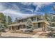 Charming two-story home showcasing brick and gray shingle siding, complemented by a spacious, welcoming front porch at 12454 Antelope Trl, Parker, CO 80138