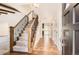 Welcoming foyer features hardwood floors, an elegant staircase with wrought iron railings, and abundant natural light at 12454 Antelope Trl, Parker, CO 80138