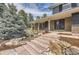 Inviting front entrance with stone steps, lush landscaping, and a tranquil water feature, enhancing curb appeal at 12454 Antelope Trl, Parker, CO 80138