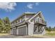 Three-car garage with an upper-level balcony, offering a unique feature and outdoor space with views of the surroundings at 12454 Antelope Trl, Parker, CO 80138