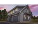Three-car garage with living quarters above, showcasing gray siding and a small balcony at 12454 Antelope Trl, Parker, CO 80138