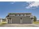 Three-car garage with gray siding, windows, and a modern roofline, offering ample parking and storage space at 12454 Antelope Trl, Parker, CO 80138