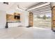 Spacious, well-lit garage with wood accent wall, storage cabinets, epoxy floor, and a view of the lush outdoors at 12454 Antelope Trl, Parker, CO 80138