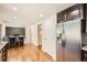 An open-concept kitchen features stainless appliances, wooden cabinets, and hardwood floors at 12454 Antelope Trl, Parker, CO 80138