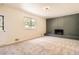 Spacious living room includes a decorative fireplace and view of the front yard at 12454 Antelope Trl, Parker, CO 80138