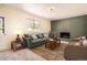Cozy living room featuring a brick fireplace, comfortable seating, and a rustic wood coffee table at 12454 Antelope Trl, Parker, CO 80138