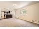 Spacious living room with a kitchen bar featuring natural light from the window at 12454 Antelope Trl, Parker, CO 80138