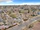 Wide aerial view showing the neighborhood's layout and diverse housing styles with mature trees lining the streets at 2455 E Yale Ave, Denver, CO 80210
