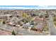 A bird's-eye view of a residential neighborhood with mature trees and distant mountain views at 2455 E Yale Ave, Denver, CO 80210