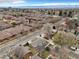 A picturesque neighborhood from above, highlighting tree-lined streets, diverse homes, and mountain views at 2455 E Yale Ave, Denver, CO 80210
