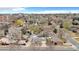 Aerial view showing single-Gathering homes, mature trees, and the city skyline in the distance at 2455 E Yale Ave, Denver, CO 80210
