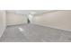 Large finished basement area with staircase access, neutral walls, and soft gray carpet at 2455 E Yale Ave, Denver, CO 80210
