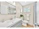 Bathroom with large mirror, a walk-in shower and neutral paint at 2455 E Yale Ave, Denver, CO 80210
