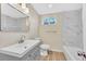 Renovated bathroom featuring new fixtures, vanity, and tub shower combo at 2455 E Yale Ave, Denver, CO 80210