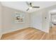 Bedroom with hardwood floors, a large closet, and easy access to the hallway at 2455 E Yale Ave, Denver, CO 80210