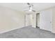 Neutral bedroom featuring gray carpet, a ceiling fan, closet, and white trim at 2455 E Yale Ave, Denver, CO 80210
