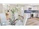 Dining area adjacent to the kitchen with glass table at 2455 E Yale Ave, Denver, CO 80210