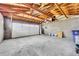 Bright garage featuring a wooden ceiling, concrete flooring, and ample room at 2455 E Yale Ave, Denver, CO 80210