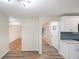 A view from the living room towards a modern kitchen with gray backsplash at 2455 E Yale Ave, Denver, CO 80210