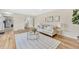 Spacious living room featuring hardwood floors and neutral-toned furniture, with open access to other rooms at 2455 E Yale Ave, Denver, CO 80210