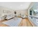 Bright living room features hardwood floors, large windows, comfortable seating, and stylish decor at 2455 E Yale Ave, Denver, CO 80210