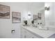 A pristine bathroom features a white vanity with quartz countertop and stylish decor at 4970 S Chester St, Greenwood Village, CO 80111