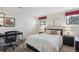 A roomy bedroom with modern lamps and a large desk for work at 4970 S Chester St, Greenwood Village, CO 80111