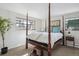 A grand main bedroom features a four-poster bed and bright windows at 4970 S Chester St, Greenwood Village, CO 80111