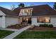 A charming home's front entrance features a cozy seating area with a well-manicured lawn at 4970 S Chester St, Greenwood Village, CO 80111