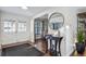 Charming foyer entrance features hardwood flooring with a mirror, table, and doors to the outside at 4970 S Chester St, Greenwood Village, CO 80111