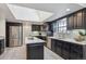 Updated kitchen featuring stainless steel appliances, island with cooktop, skylight and ample cabinet space at 4970 S Chester St, Greenwood Village, CO 80111