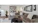 Comfortable living room featuring modern shelving, large sofa, and a cozy rug at 4970 S Chester St, Greenwood Village, CO 80111