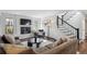 Comfortable living room featuring a fireplace, plush sofa, and a cozy rug at 4970 S Chester St, Greenwood Village, CO 80111